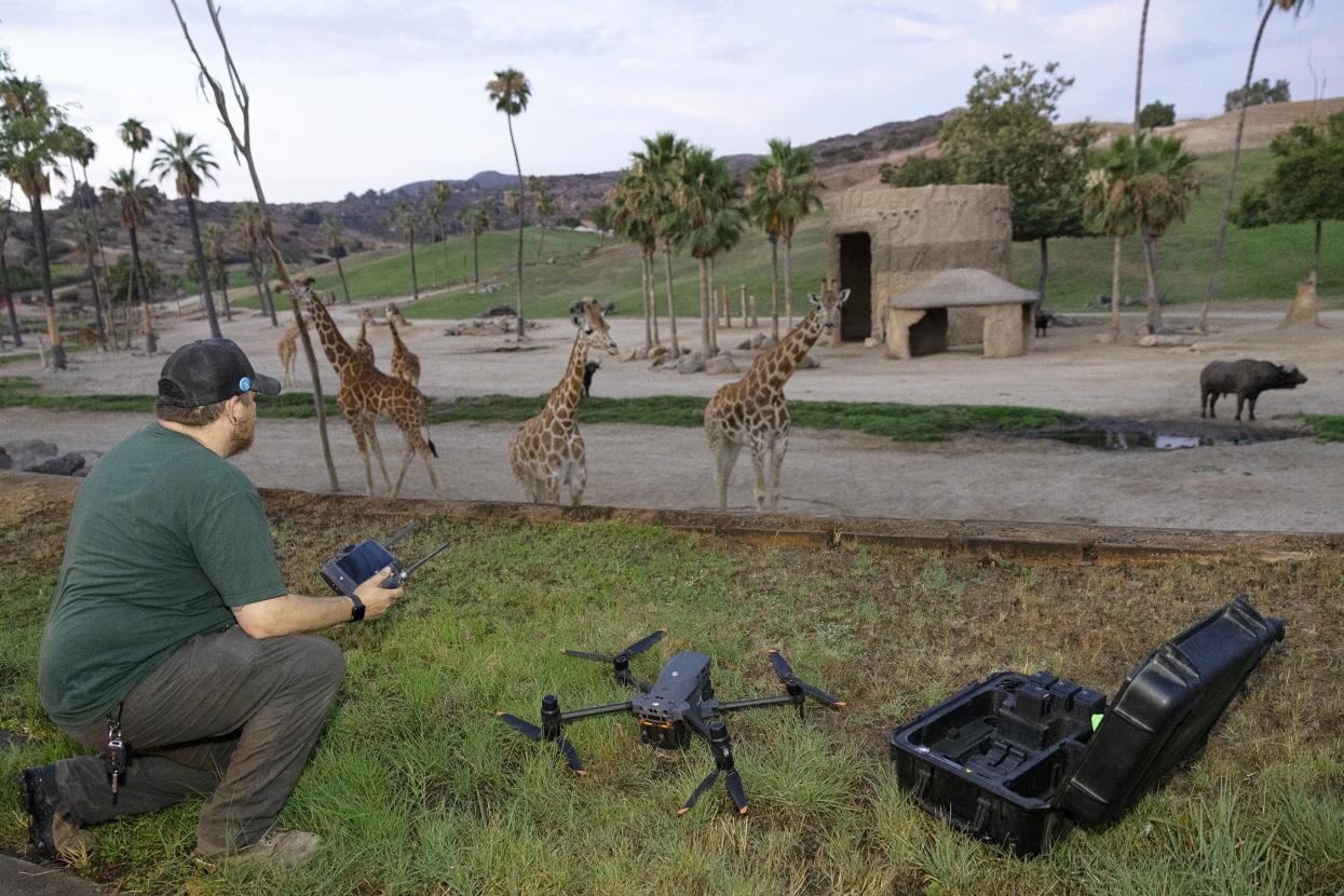 Author in green shirt operating a drone.