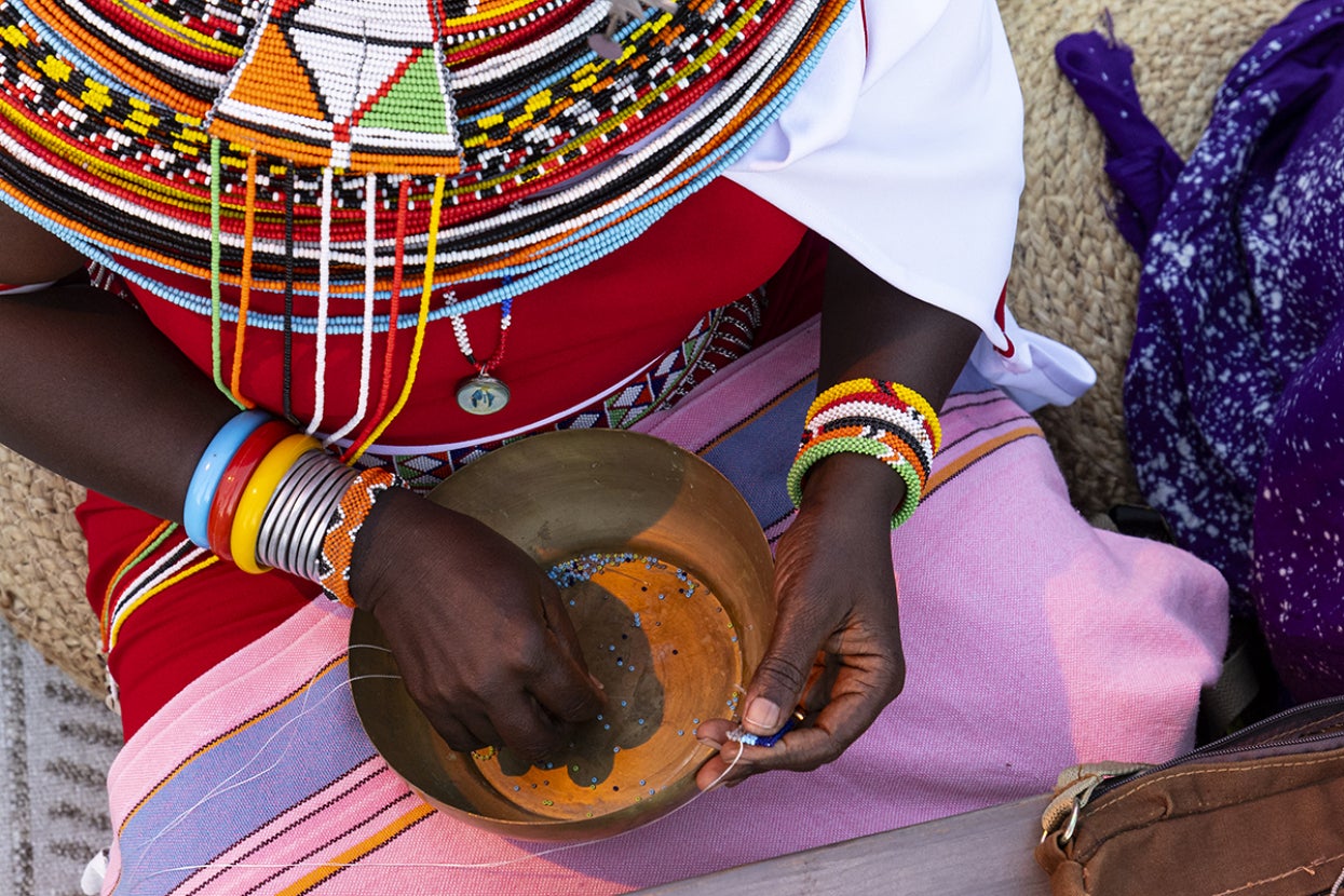Woman holding bowl of beads