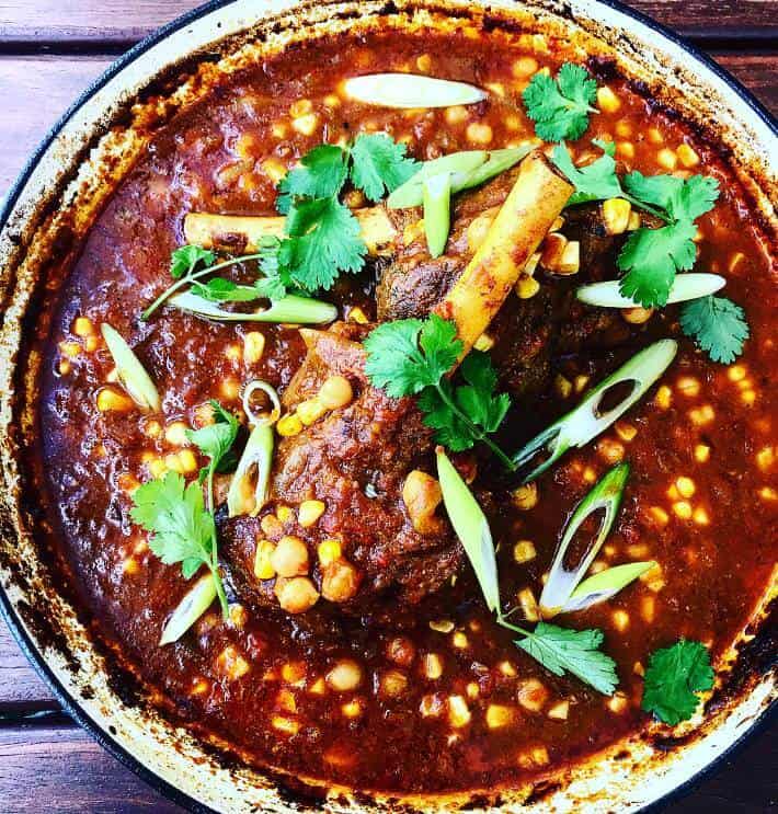 lamb shanks cooking in chickpea curry 