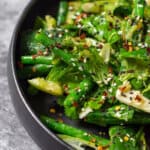 smashed cucumber salad in a black bowl