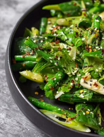 smashed cucumber salad in a black bowl