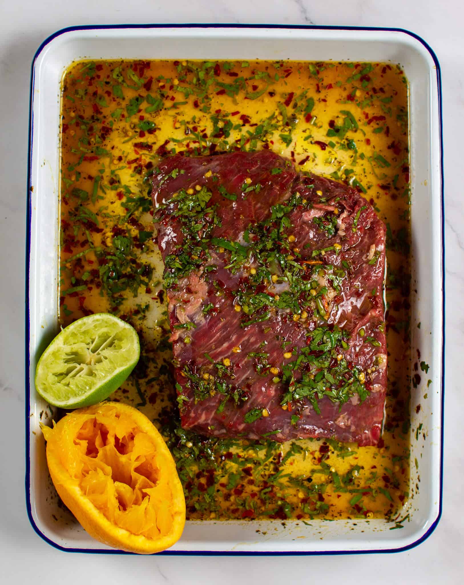 flap steak being marinated carne asada style