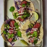 3 steak tacos - carne asada style on a tray
