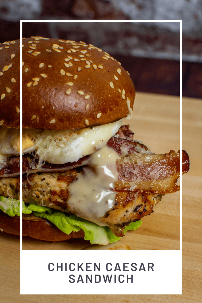 chicken caesar sandwich on wooden chopping board