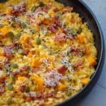 black bowl with pumpkin pork risotto in