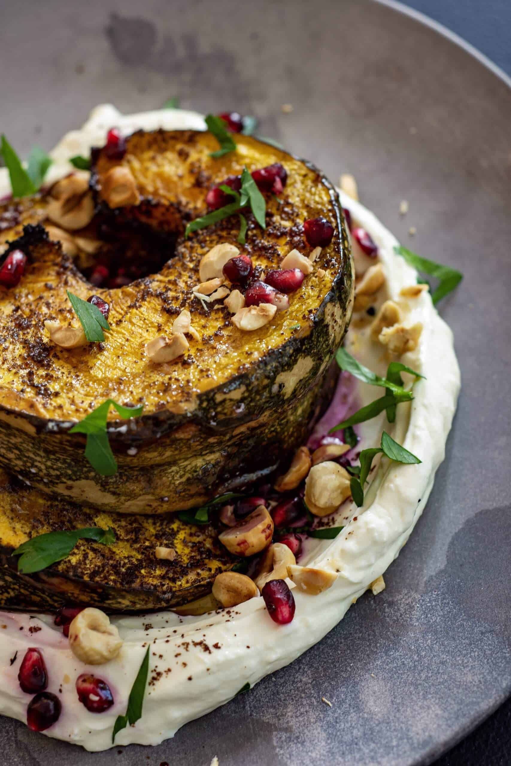 Sumac Roasted Pumpkin Sumac Roasted Pumpkin on a plate with labne , hazelnuts & pomegranate