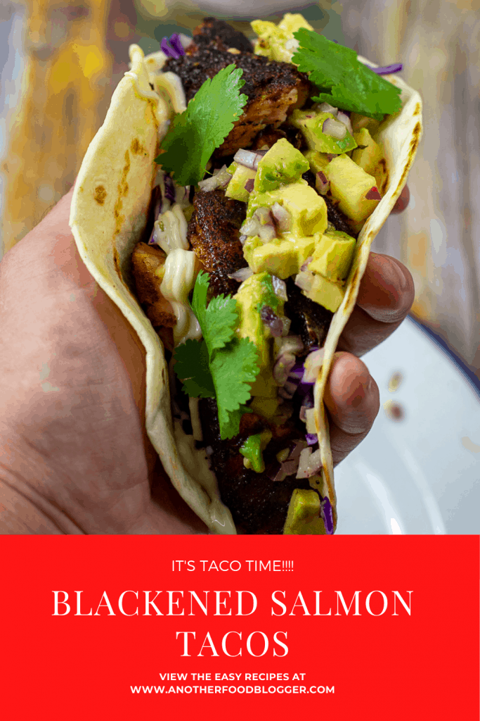 someone holding a blackened salmon taco