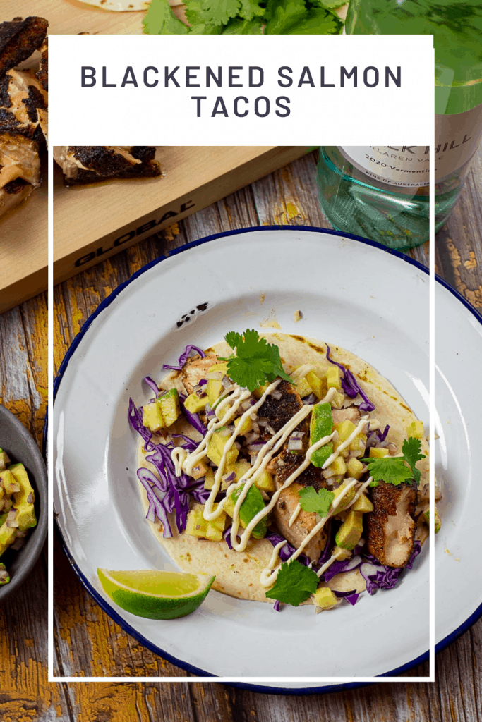 blackened salmon taco on a plate with chalk hill vermentino in background