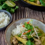 thai green curry, rice, herbs & lime on a table