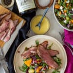 grilled lamb & veg salad, bottle of red wine and cooked sliced lamb