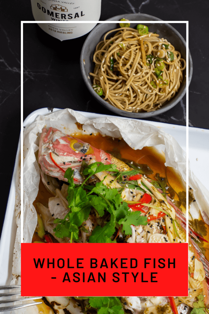 Cooked fish en papillote with bowl of noodles