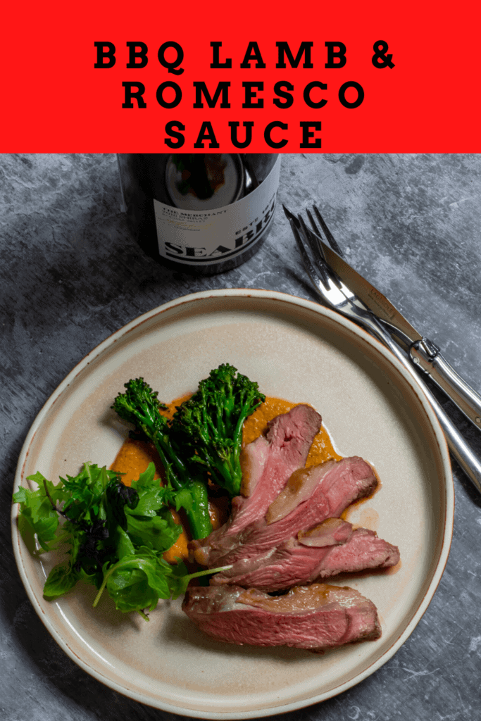 Seabrook wine shiraz, cooked lamb, macadamia romesco sauce & charred broccolini on a table