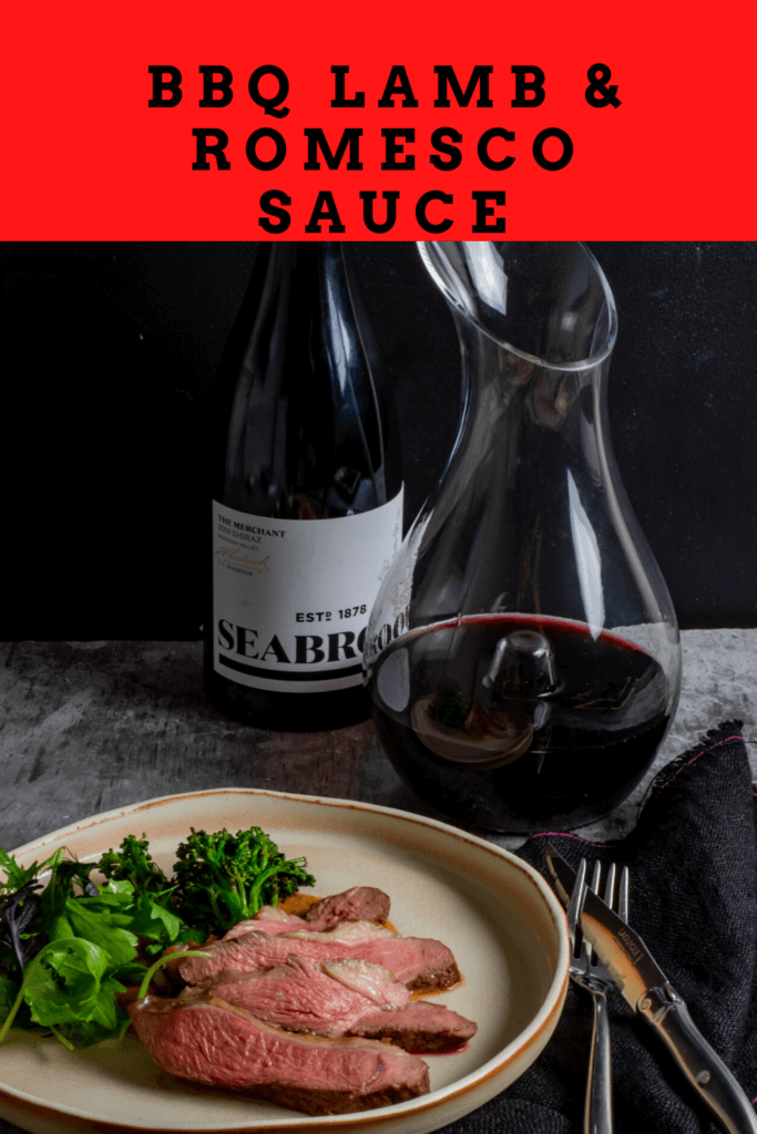 Seabrook wine shiraz, wine decanter, cooked lamb, macadamia romesco sauce & charred broccolini on a table