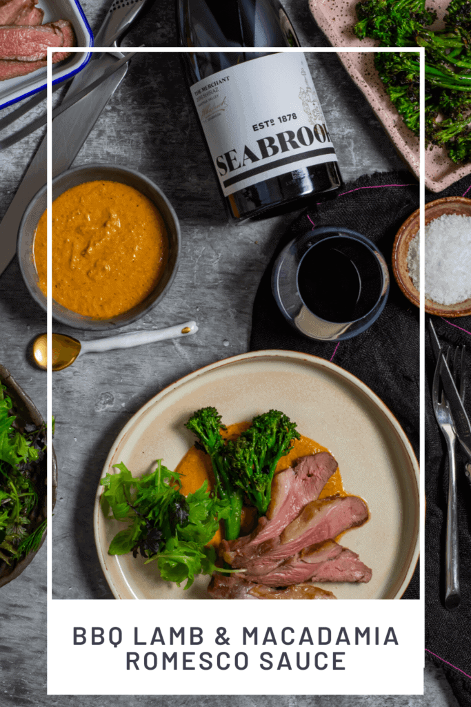 Seabrook wine shiraz, BBQ lamb, romesco sauce & charred broccolini on a table