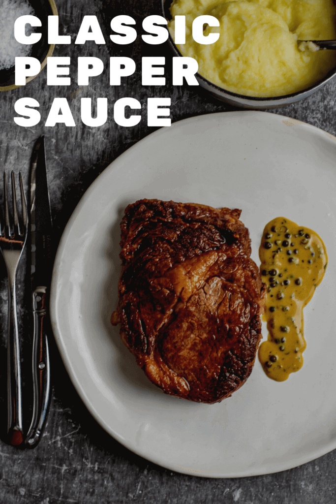 Rib fillet, pepper sauce, mashed potatoes and cutlery on a table