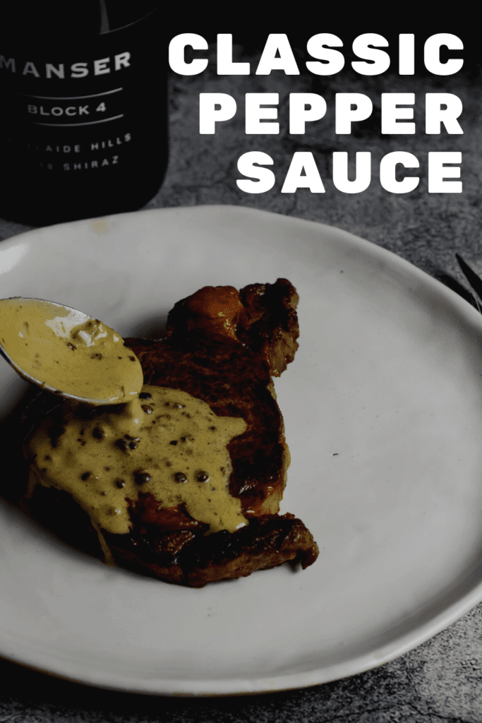 peppercorn sauce being spooned over steak & manser red wine
