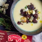 Potato & leek soup with clonakilty black pudding next to it