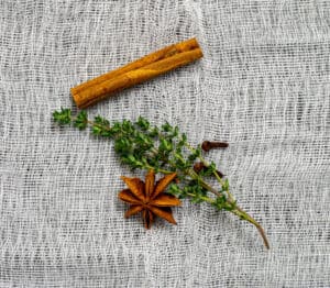 anise, clove, thyme & cinnamon on muslin cloth