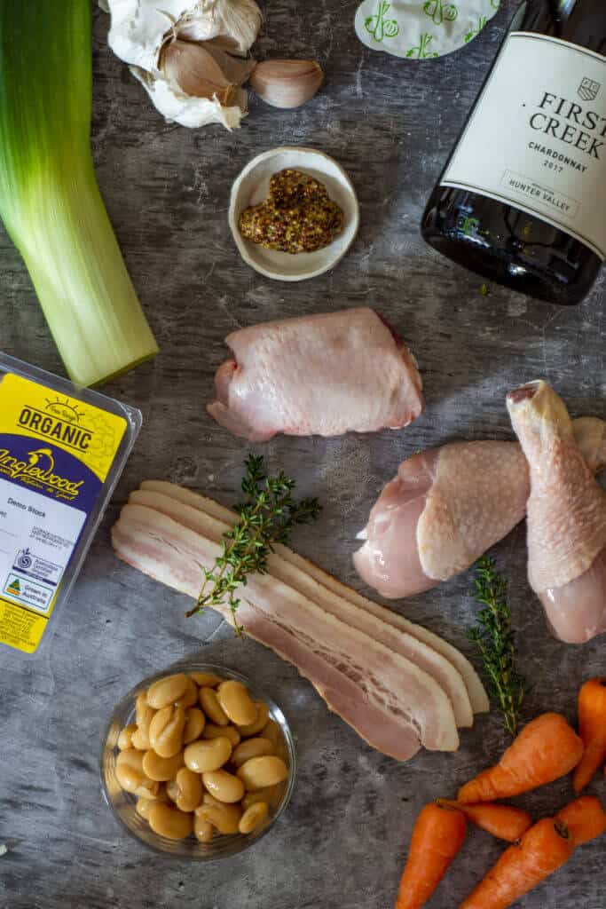 Ingredients for chicken cassoulet and a bottle of chardonnay