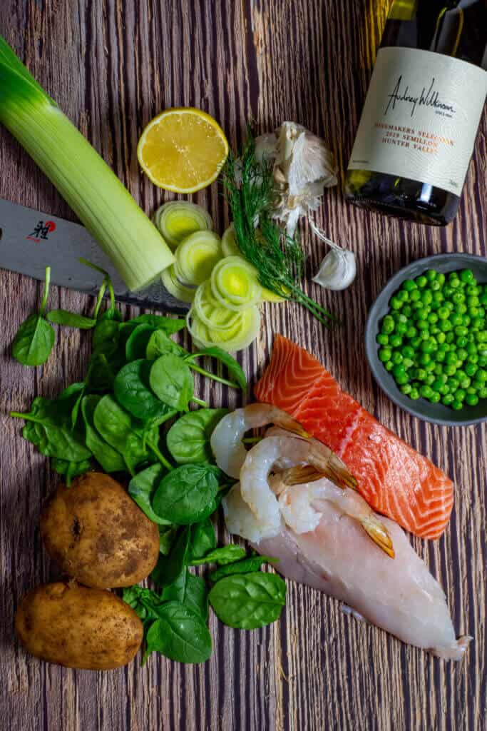 Fish pie ingredients and a bottle of wine