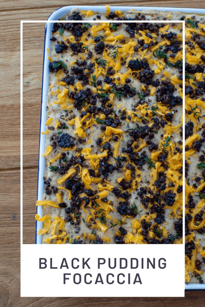 Black pudding focaccia in baking tray on wooden table