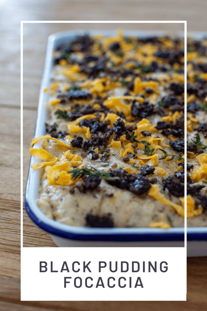 Black pudding focaccia in baking tray on wooden table