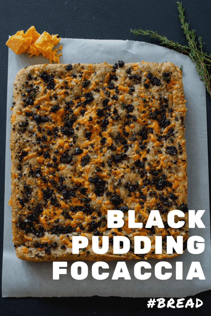Black pudding & cheddar cheese focaccia with thyme on a black board