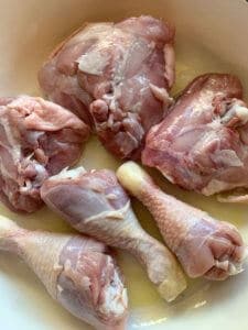 chicken thighs & drumsticks browning in pan