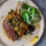 crumbed veal cutlet sliced in half with lemon caper sauce and salad