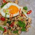 Szechuan fried chicken, rice and fried egg in a bowl