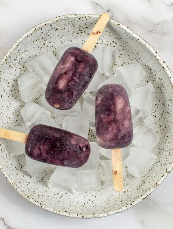 3 acai ice pops in a bowl of ice
