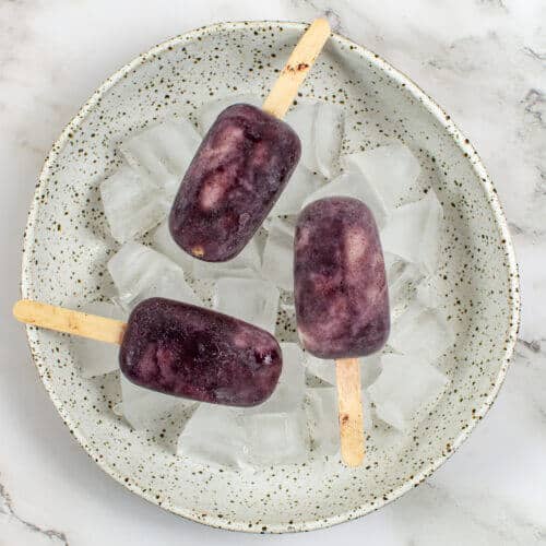 3 acai ice pops in a bowl of ice