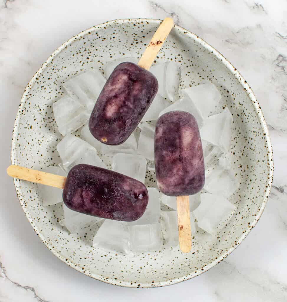 3 acai ice pops in a bowl of ice