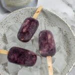 3 acai ice pops in a bowl of ice with packet of slofoodgrp acai