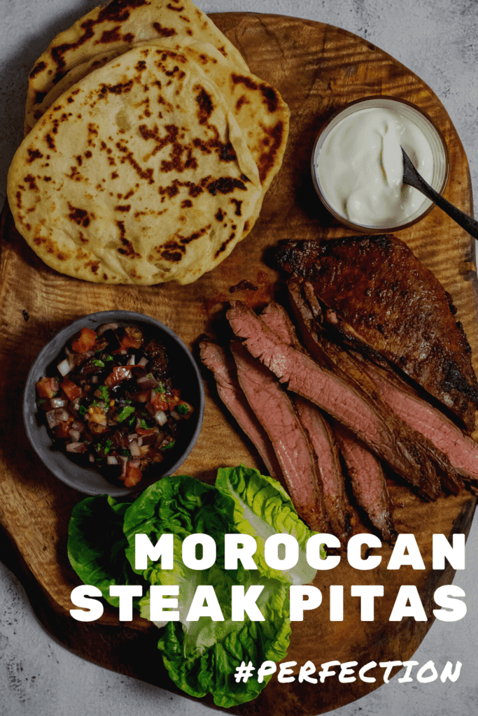 homemade pita bread, skirt steak, lettuce & salsa on wooden board