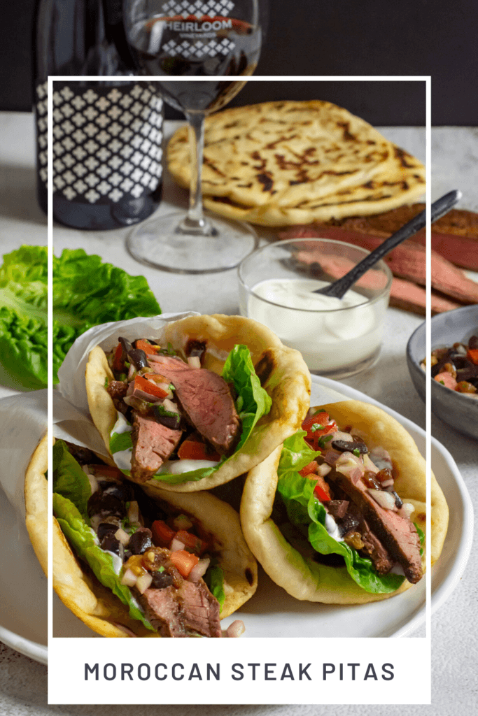 red wine, morrocan steak pitas, yoghurt & steak on a table