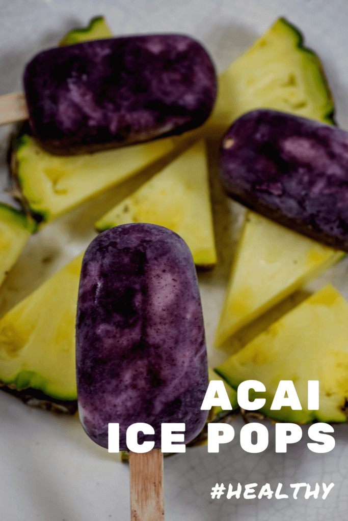 Acai ice pops on top of cut pineapple pieces