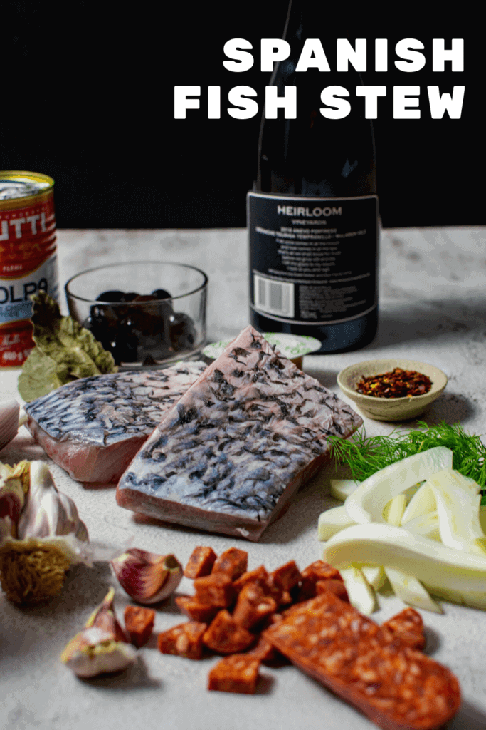 bottle of heirloom wine, barramundi, chorizo & vegetables on counter top