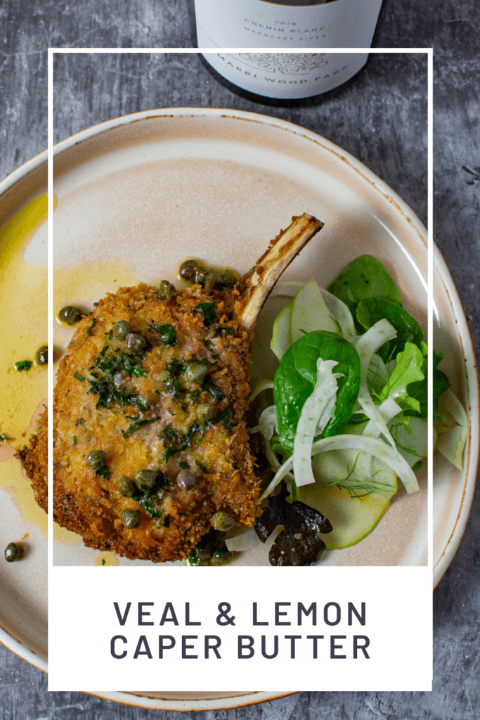 cooked veal cutlet, salad & sauce on a plate