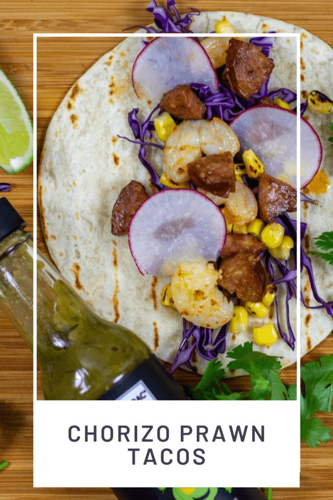 chorizo & prawn tacos on chopping board with sabarac hot sauce