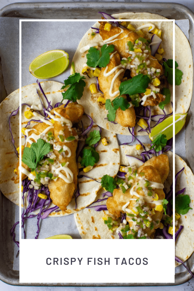 birdseye view of 3 crispy fish tacos on a tray