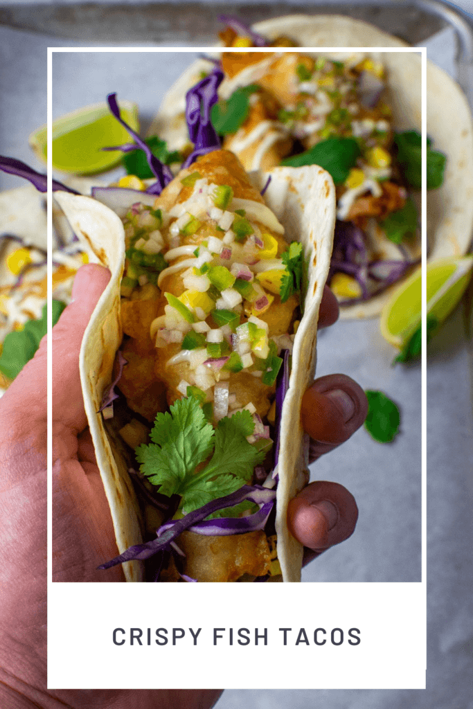 someone holding a crispy fish taco