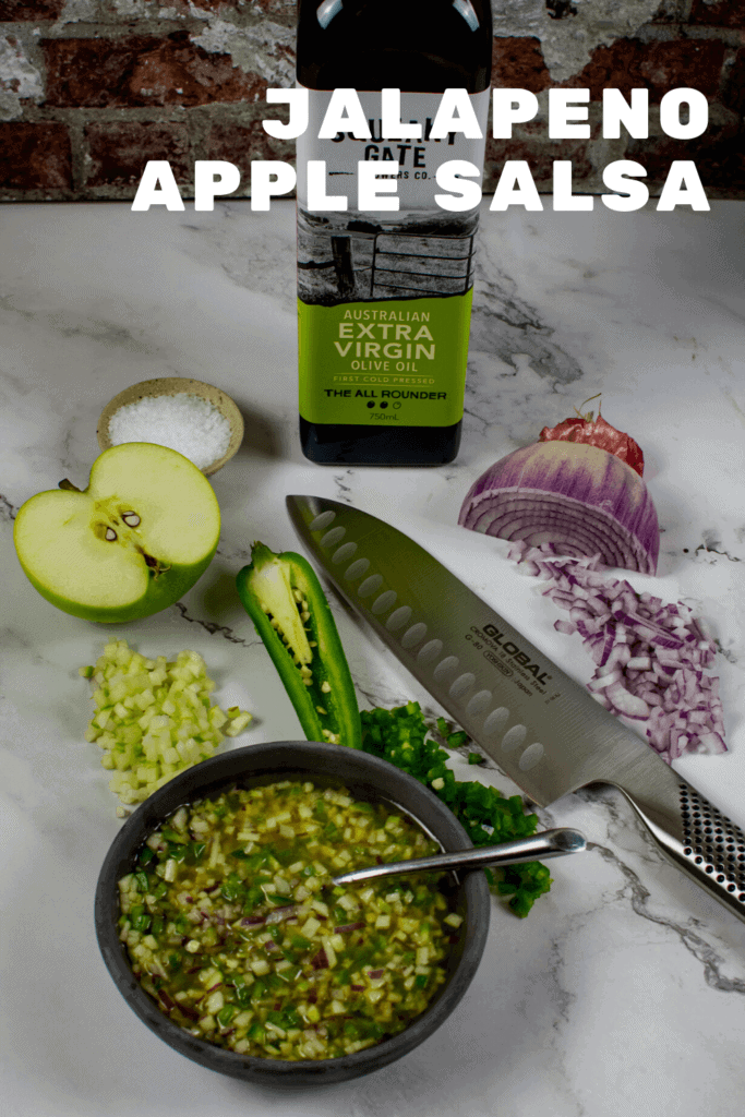 olive oil, apple, jalapenos, global chef knife & salsa on counter top