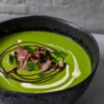 A bowl of pea & ham soup on kitchen countertop
