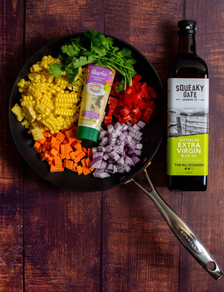 squeaky gate olive oil, scanpan pan & vegetables on a table