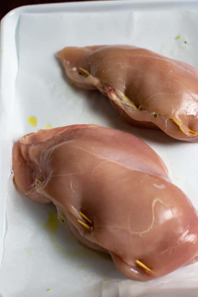 jalapeno popper stuffed chicken on a baking tray