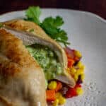 jalapeno popper stuffed chicken on white plate with corn hash