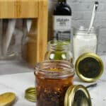 pickled raisins in kilner jar, global knived in background and sugar in a kilner jar