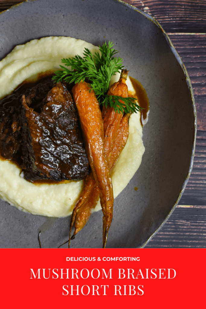 mushroom braised short ribs, cauliflower puree & carrots in a bowl on wooden table