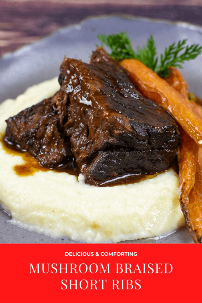 mushroom braised short ribs, cauliflower puree & carrots in a bowl on wooden table